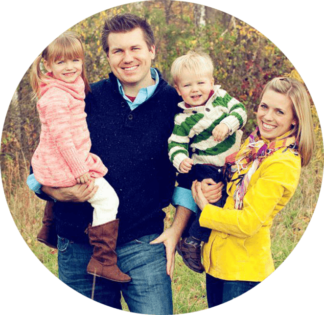 Dr. Pringle with his wife and kids smiling outside on a beautiful day.