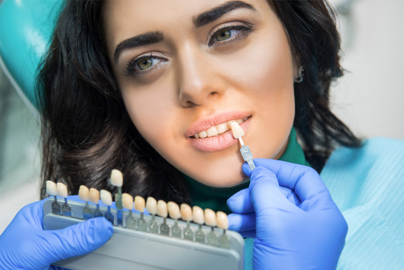 Very nice lady with dark hair getting her teeth colored at Wellington Family Dentistry & Implant Center