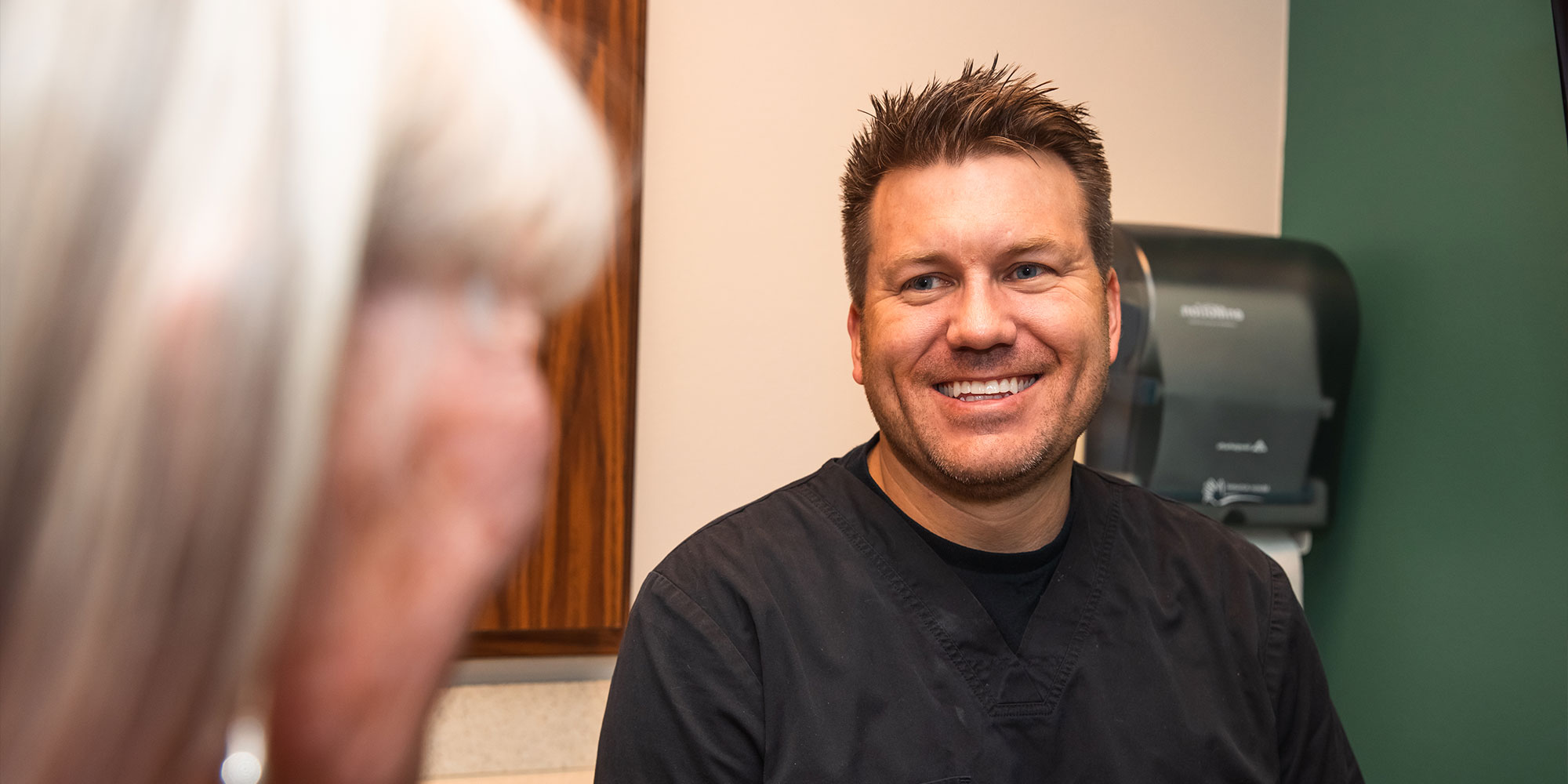 Doctor going over dental procedure information with patient within the dental office