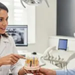 Dentist explaining dental implant lifespan to a patient in a modern clinic setting